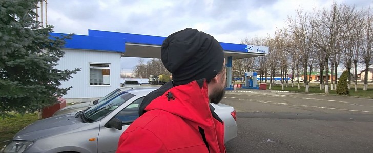 Russian Man Checks Gas Prices After Sanctions