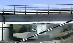 Russian Truck Driver Ignores Low Bridge