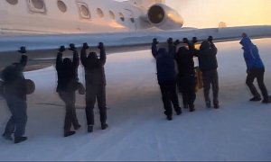 Russians Push an Airplane in Siberia after Its Wheels Froze to the Ground