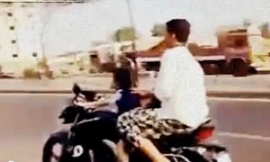 Safety and Law Fail: 4-Year Riding a Motorbike in Traffic