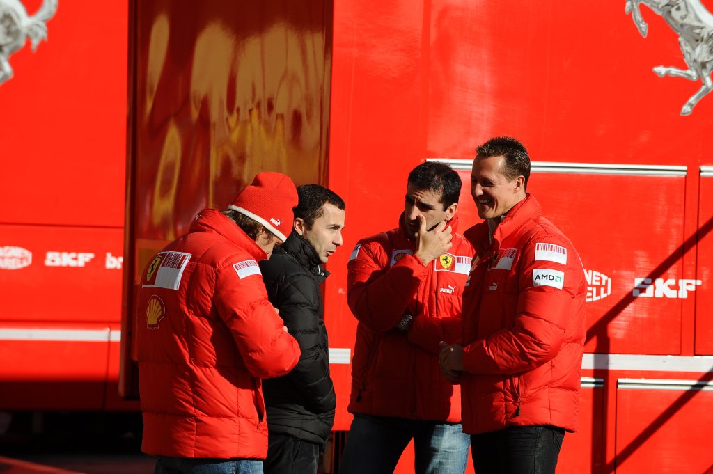 Michael Schumacher, having a chat with test drivers Luca Badoer and Marc Gene and Massa's manager Nicolas Todt