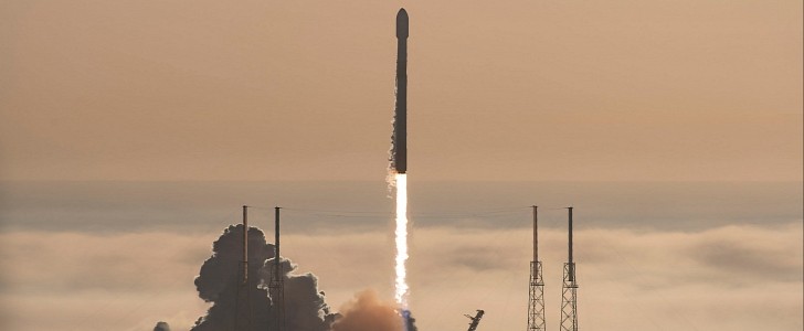 SpaceX Falcon 9 rocket rises above a thick layer of fog