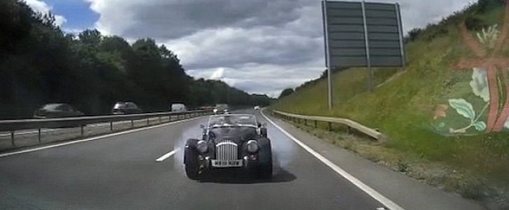 Morgan Plus 4 speeds towards stalled Audi SUV, moments before impact