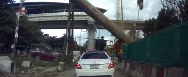 Steel pile knocked over by crane falls on Mercedes Saloon