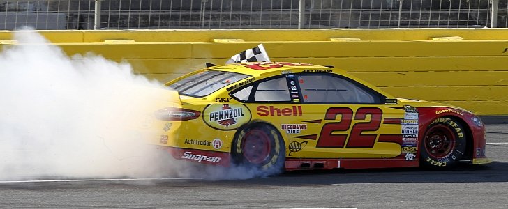 Joey Logano does a burnout at Charlotte Speedway in 2015