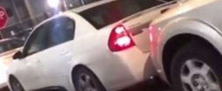 Driver pushes SUV for parking too close to his own car