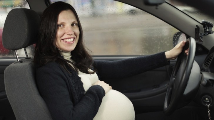 Pregnant woman behind wheel