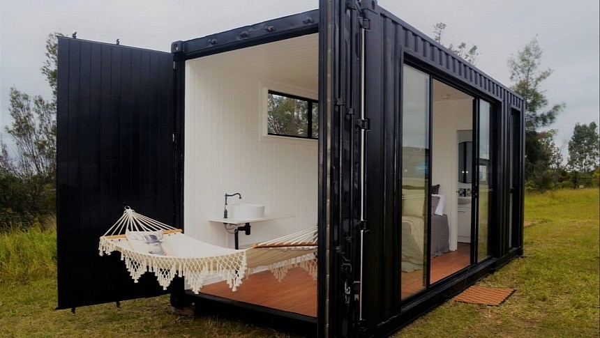 This luxury container home opens to the outdoors through the back