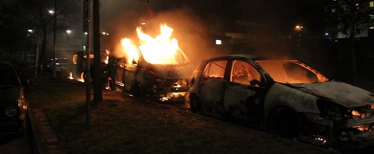 Second day of the Stockholm Husby riots. The picture depicts three cars recently put to fire in the Stockholm suburb of Husby in 2013