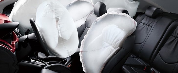 Car interior with deployed airbags