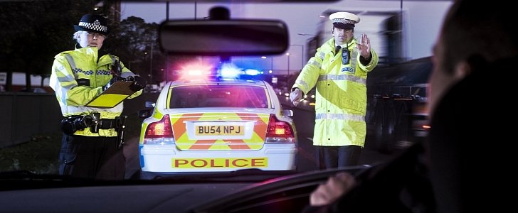 British Police Officers pull over a driver for a check