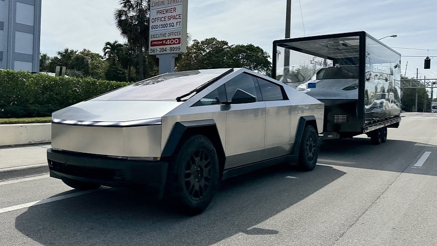 The Tesla Cybertruck is towing a trailer with the Model Y on it
