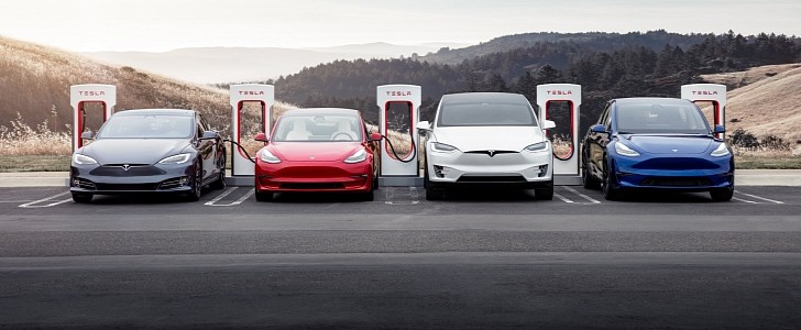 Tesla vehicles being charged at a Supercharger station
