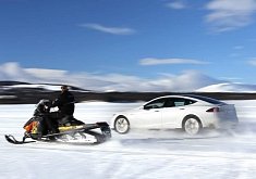 Tesla Model S P85D Drag Races a Snowmobile on Ice Lake in Norway