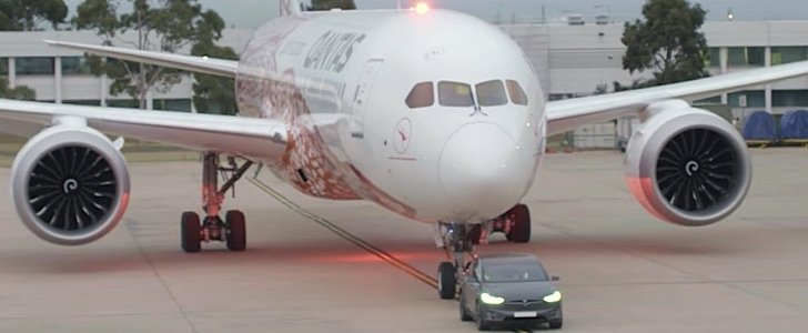 Qantas airliner towed by a Tesla Model X