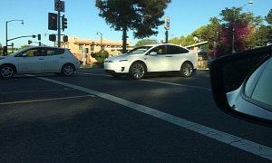 Tesla Model X Spied Again in California, Gets Photobombed by Nissan Leaf
