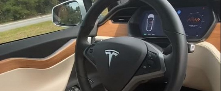 Tesla owner lets car drive itself while he chills in the passenger seat