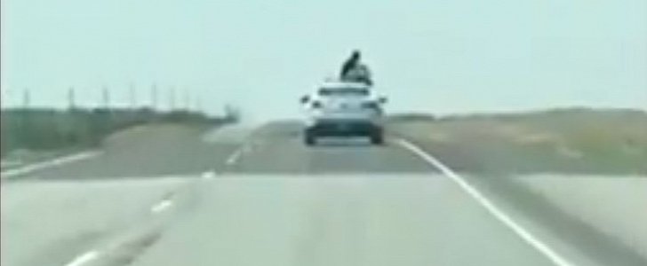 Inmate breaks out of speeding patrol car, climbs on top and gets stuck there