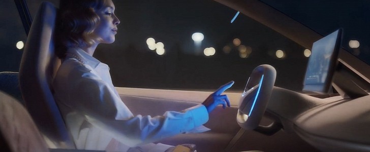A Woman Sitting Behind the Wheel of the BMW Vision iNEXT