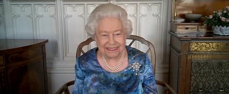 The Queen giggles when she hears athlete has been training by pushing a car up the hill