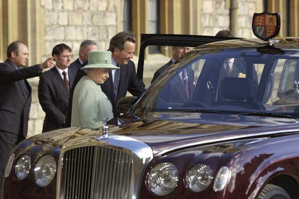 Queen Elizabeth II and one of her Bentleys