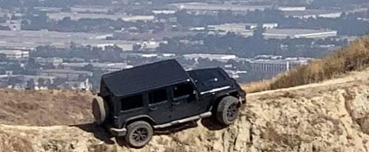A Jeep Wrangler abandoned on a narrow bike trail in California
