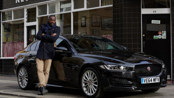 Idris Elba next to the Jaguar XE he'll be driving to Berlin