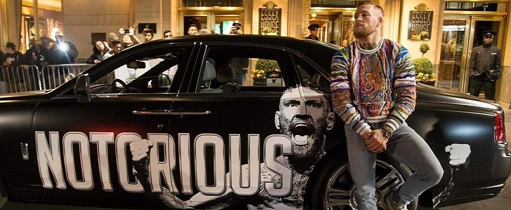 Conor McGregor leans on his brand new, customized Rolls Royce Ghost