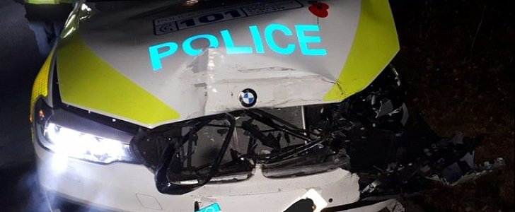 Wrecked BMW police cruiser after car thieves back stolen Land Rover into it