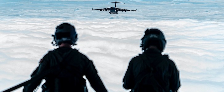 Airmen looking out the rear of a C-17 Globemaster III