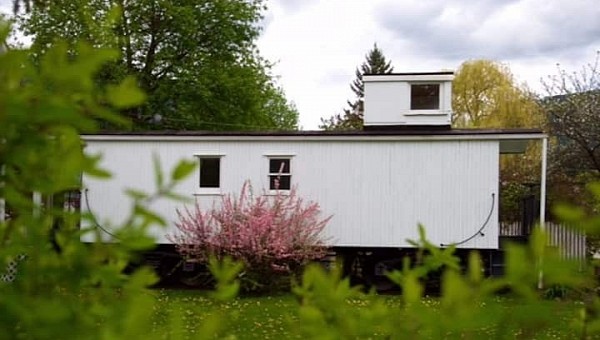This modern tiny farmhouse is in fact a vintage caboose