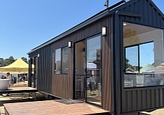 This Single-Story Tiny Home With Two Glass Entrance Doors Blends Indoor and Outdoor Living