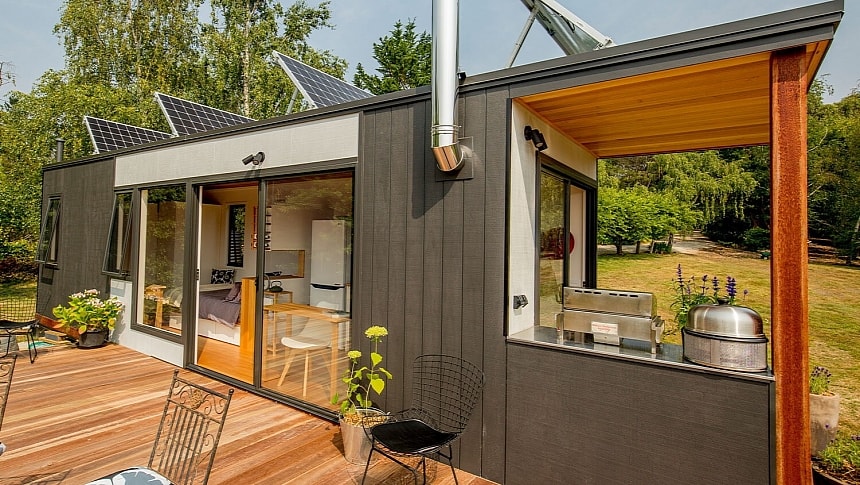 This custom tiny home boasts a sophisticated modern layout and a built-in BBQ deck