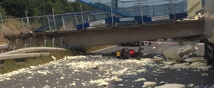 Crashed motorcycle under collapsed bridge
