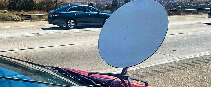 Driver straps Starlink satellite dish on the hood of his Toyota Prius