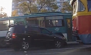 Toyota SUV Driver Gets Pinned Between Tram and Bus