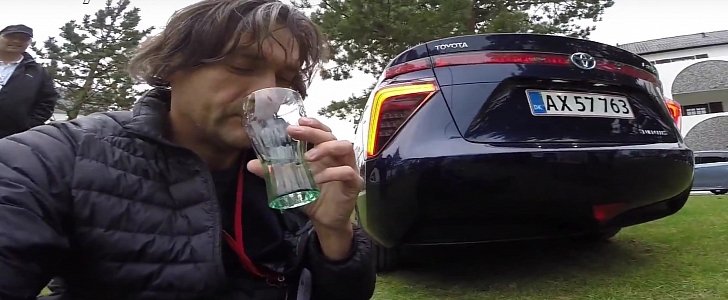 Journalist drinks water from a Toyota Mirai exhaust. The car is that clean