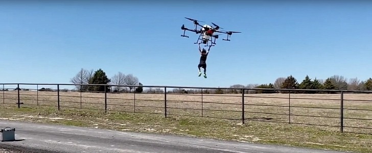 Guy lifts his kid using a drone