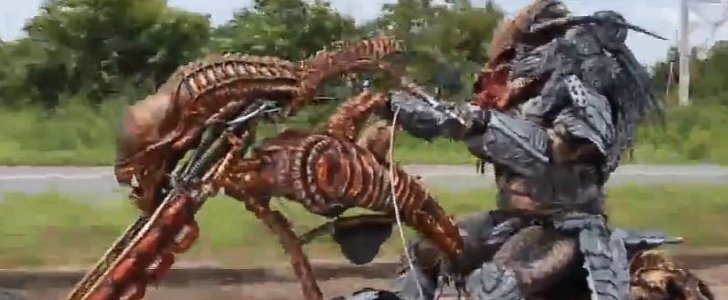 Man in full Predator suit rides an Alien-shaped bike
