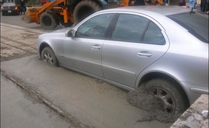 Mercedes-Benz E-Class stuck in concrete.