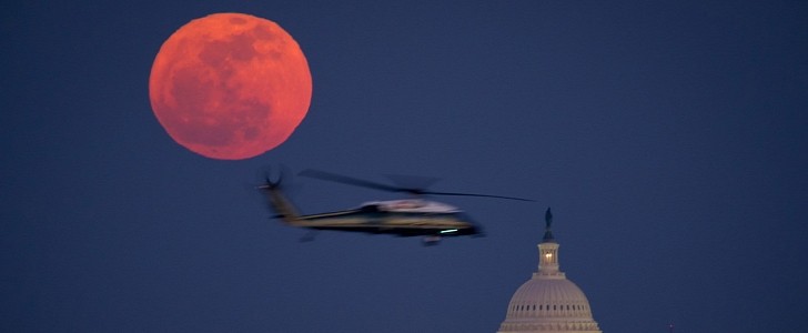 U.S. Marine Corps helicopter is seen flying in front of the full Moon on Tuesday, Feb. 7, 2012 