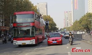 Wedded Couple Levitating Off the Side of a Double-Decker Steals the Show in China