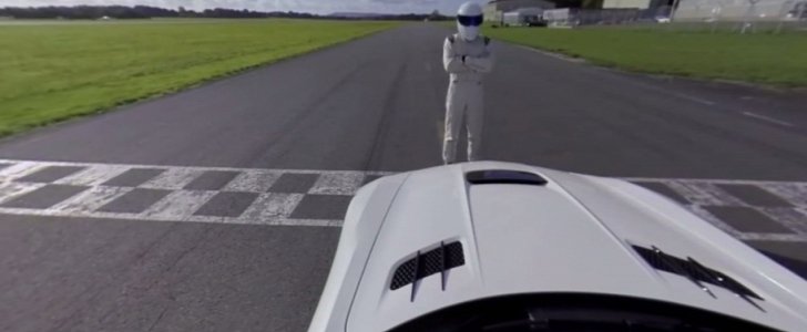 The Stig sitting in front of a Mercedes-Benz AMG SLS