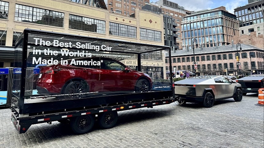 The Tesla Cybertruck is towing a trailer with the Model Y on it in New York City