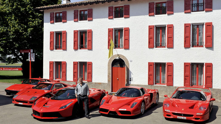 Jon Hunt poses near some of his Ferrari collection