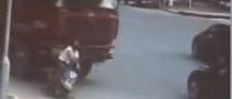 Woman is Knocked Off Bike, Ran Over by Truck, Survives