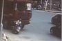 Woman is Knocked Off Bike, Ran Over by Truck, Survives