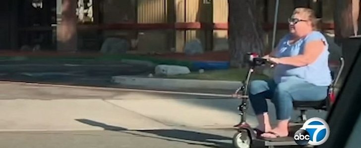 Woman on motorized scooter is pulled by car on busy California road 