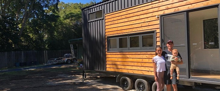 A young couple with two young children is happily living in a mobile tiny home